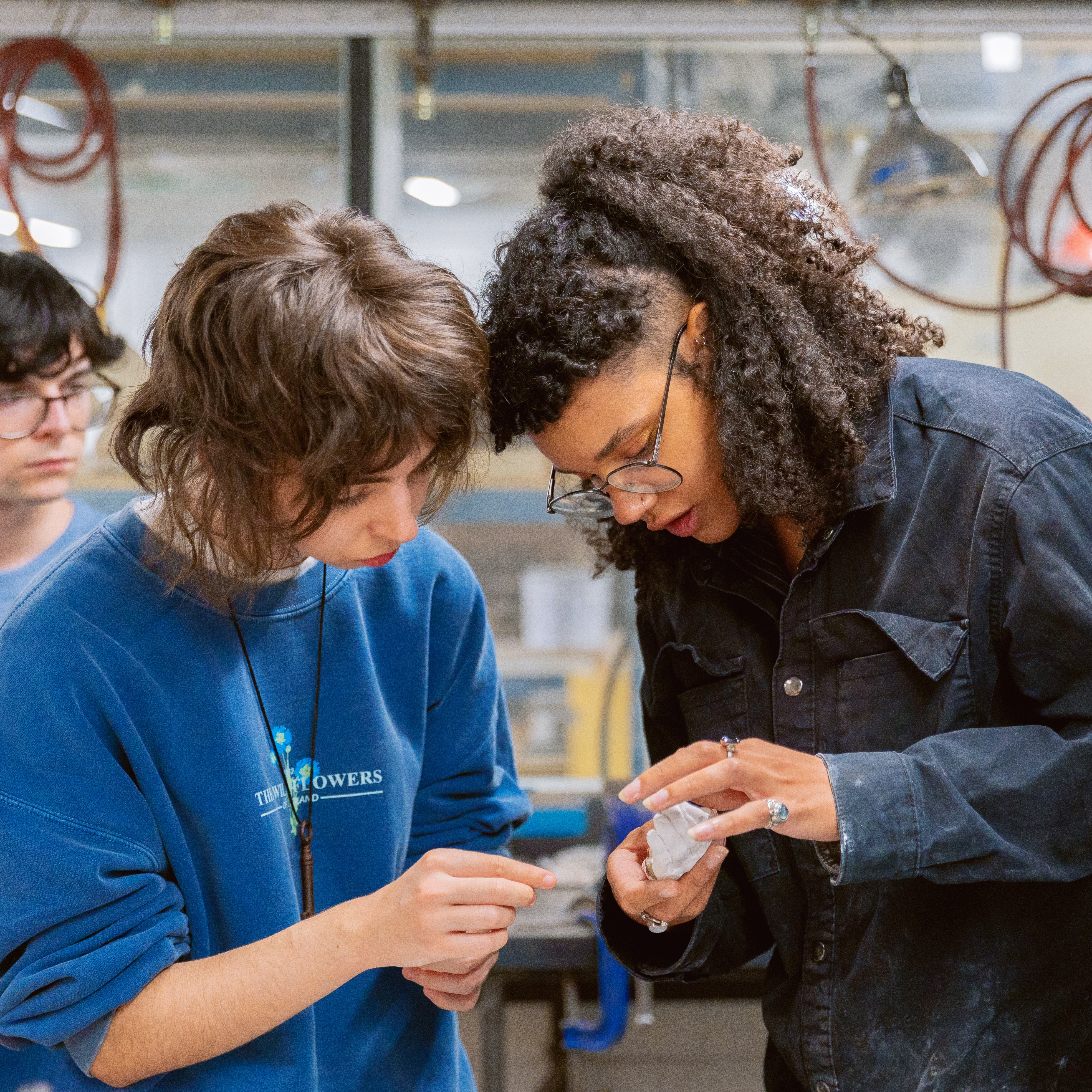 Residency participant and class assistant working in mould-making studio