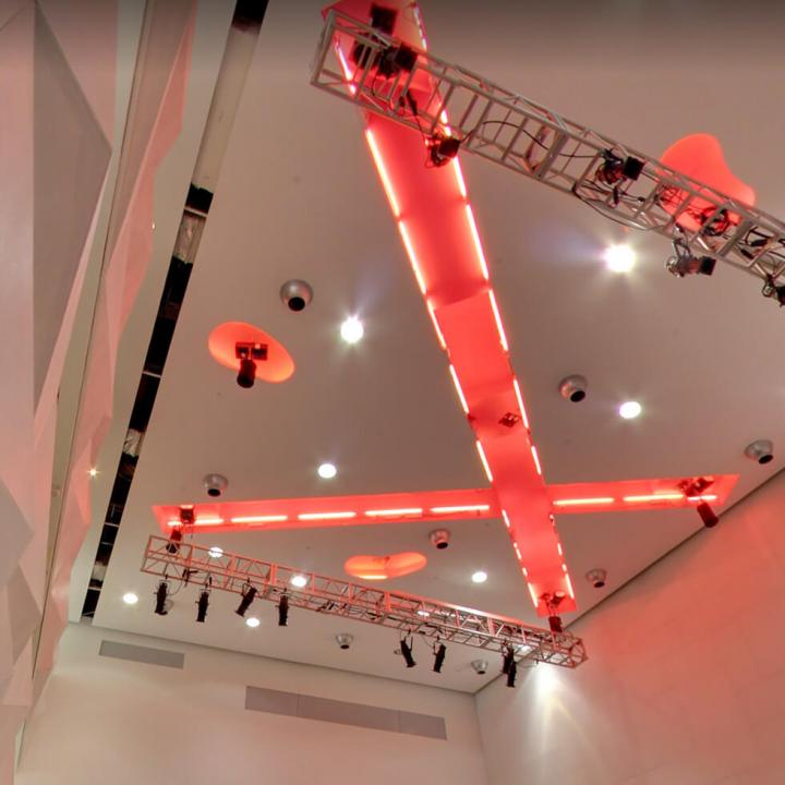 Ceiling of OCAD U's great hall. Two large lines of light criss-cross on the ceiling. 