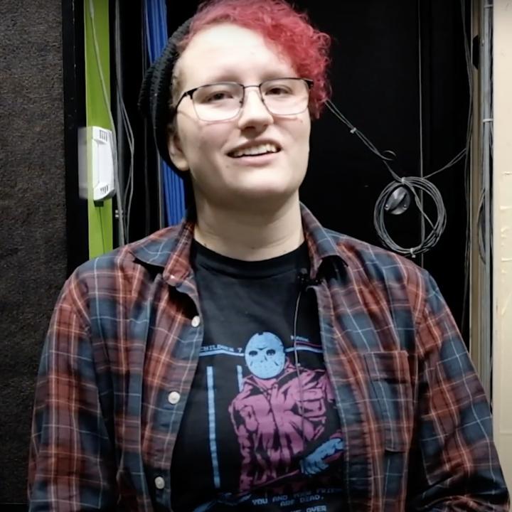 Student sitting in a recording studio. 