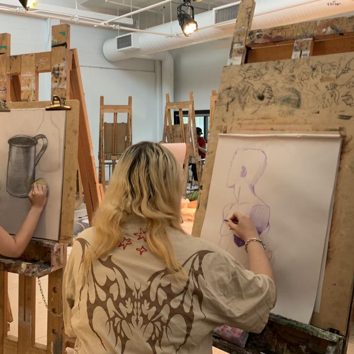 Student sketching in a life drawing studio