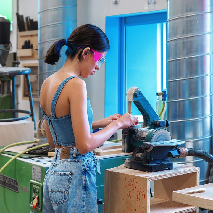 Student using a scroll saw in a woodshop
