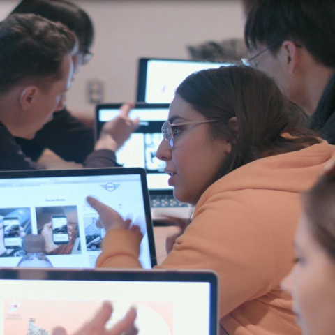students discussing work on a computer 