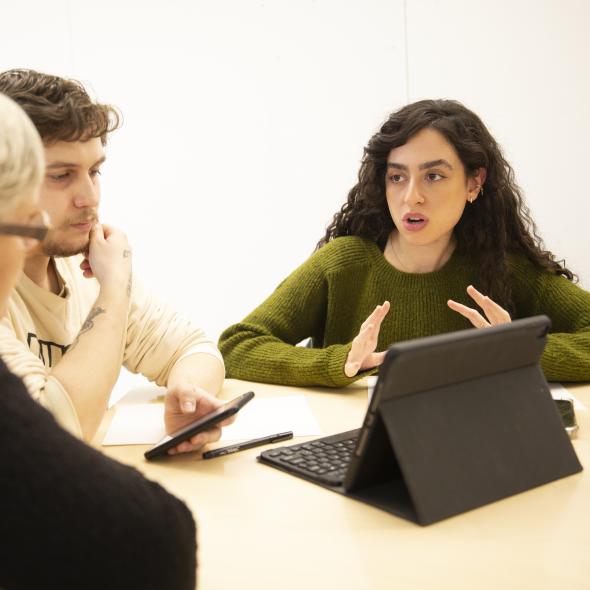 Students talking animatedly at a table